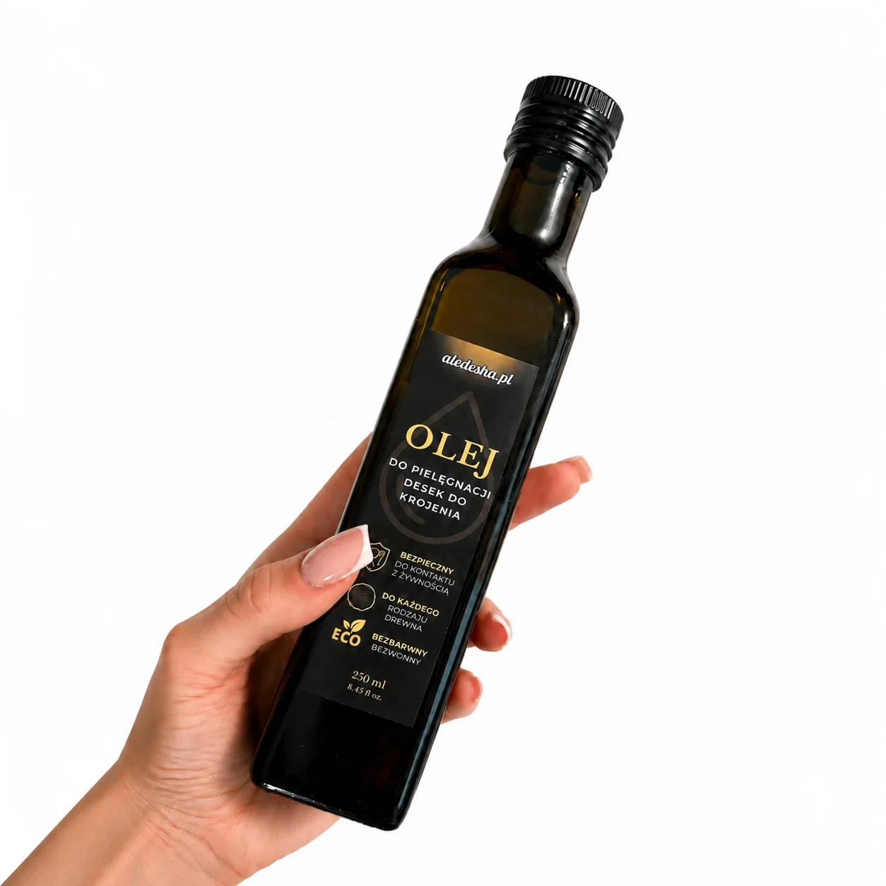 Dłoń trzymająca butelkę oleju mineralnego do pielęgnacji desek, 250 ml