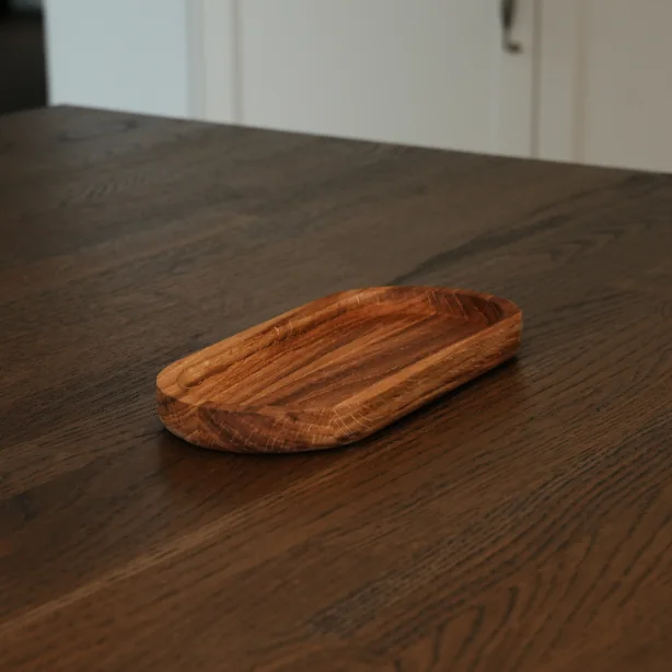 Owalna patera dębowa Dorcia 22 × 10 cm na ciemnym drewnianym stole